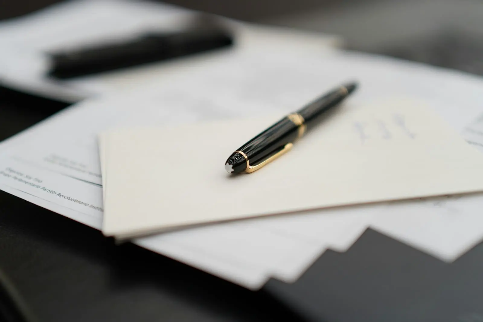 Pen resting on retirement account paperwork, illustrating the documentation work behind a backdoor Roth IRA conversion