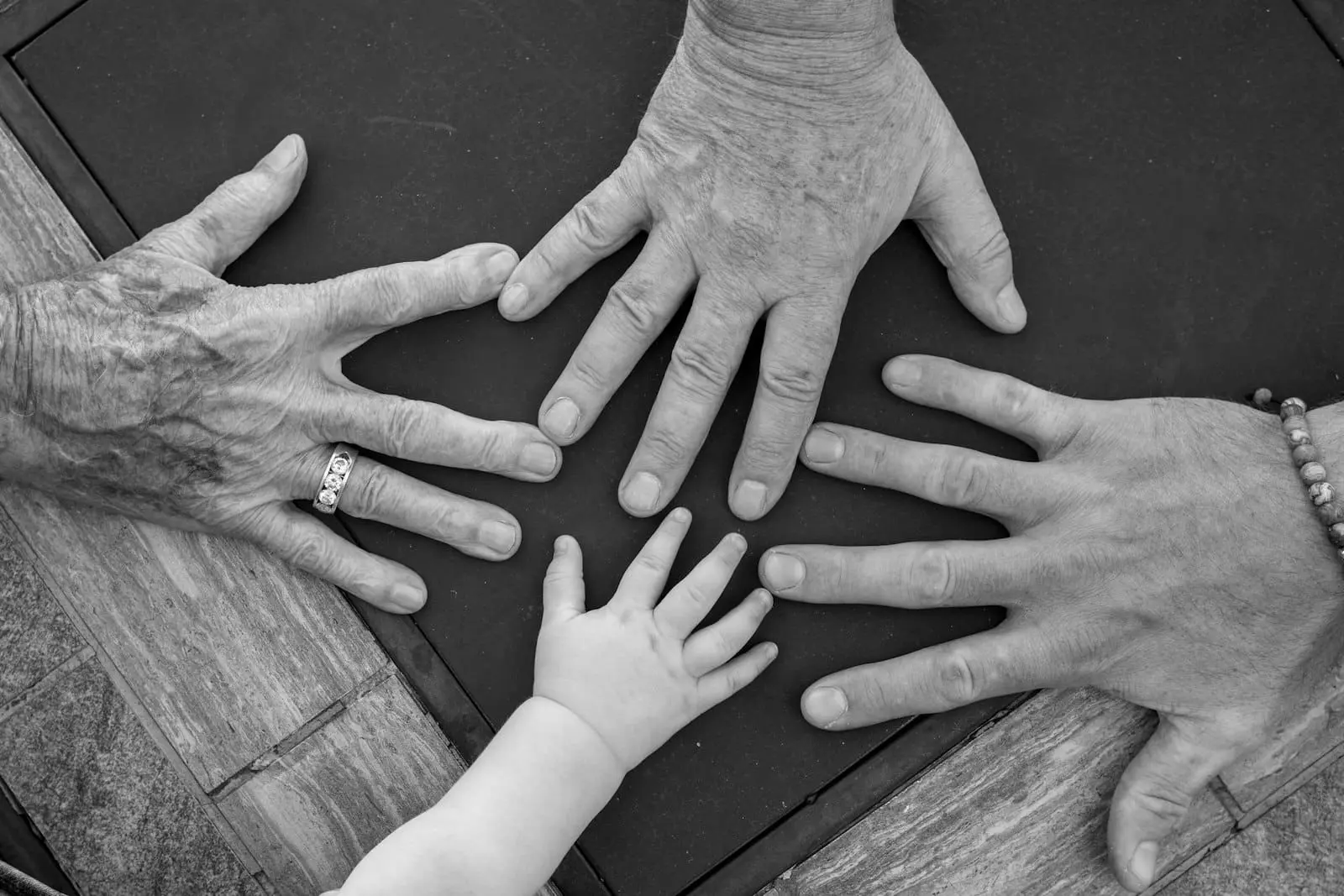 Hands of different generations reaching together, illustrating the intergenerational wealth transfer affected by the April 2027 pension IHT changes