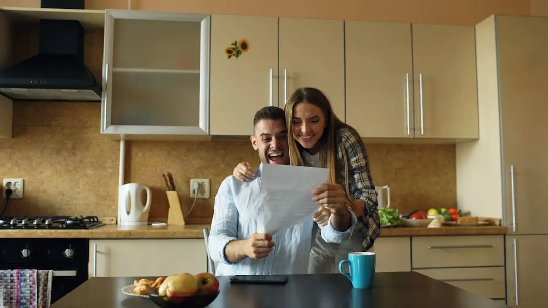 An older American couple reviewing their retirement savings at a kitchen table