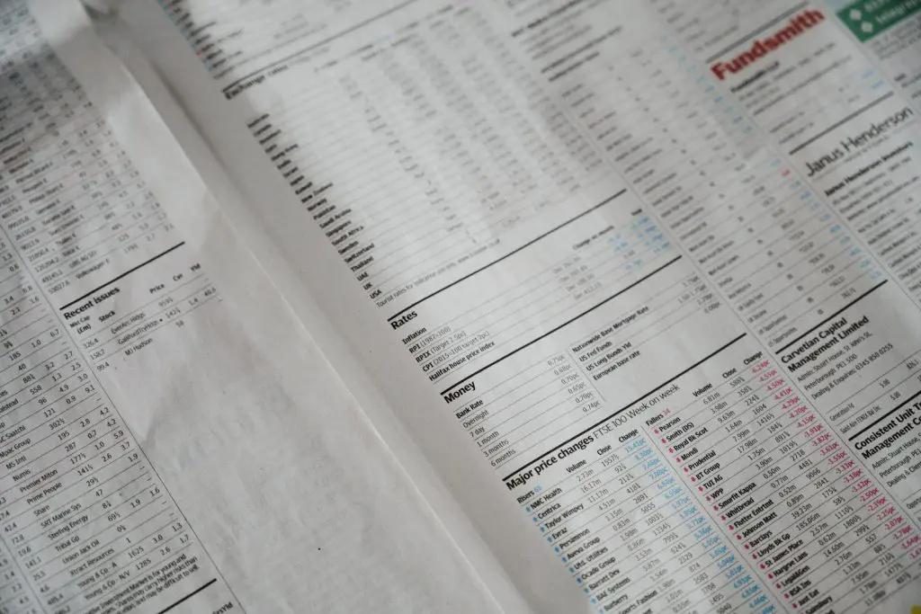 Finance section of a newspaper showing stock and bond listings, illustrating the UK bond consolidated tape launched by the FCA in June 2026