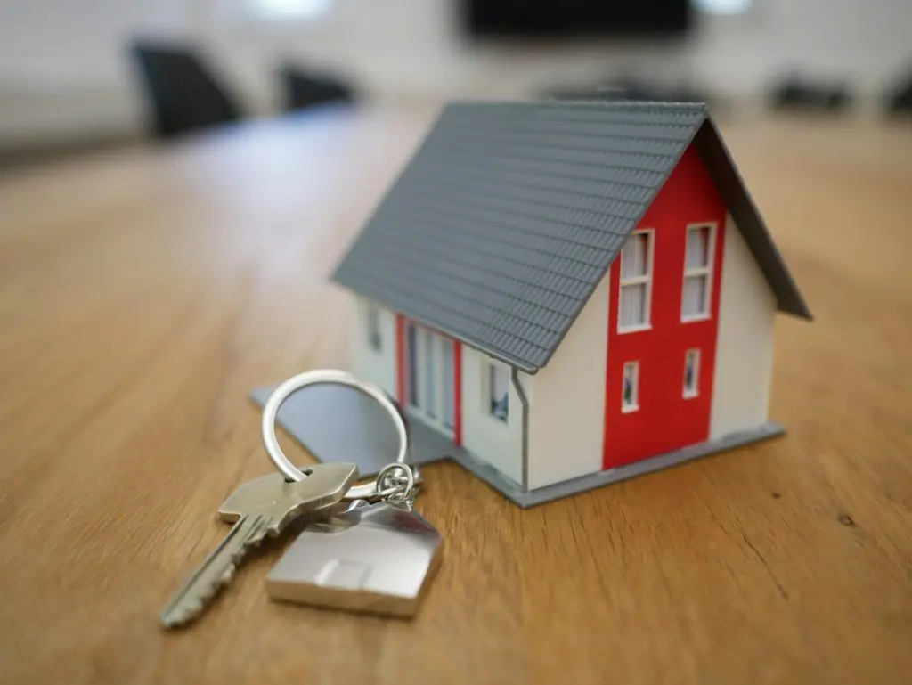 A set of house keys resting on a property purchase document, representing a first home